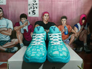Front view showing the patterned toe boxes, white laces, and Kobe-style tongue logos.