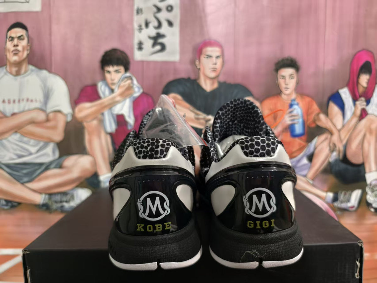 Rear view of black basketball shoes with Kobe and Gigi heel lettering and a black and white patterned collar