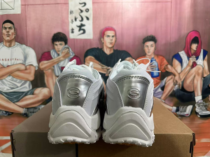 Rear view of white G-TEK sneakers with silver-tone heel panels