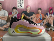Side view of pink and black Jordan basketball shoes with lime and orange accents.