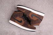 Overhead view of the pair showing the brown and black panel layout and white midsoles.