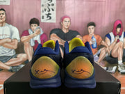 Rear view showing the contrasting yellow-green heel panels, navy collars, and visible heel graphics.
