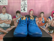 Front view of blue basketball shoes with textured uppers and gold-tone tongue panels