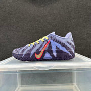 Lavender and navy low-top basketball shoe with yellow laces and a coral-accented side logo