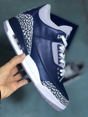 Side view of a navy and grey sneaker with elephant-print overlays and a visible heel air unit.