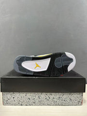 Underside view of the sneaker showing the black and gray patterned rubber outsole with a yellow logo detail.
