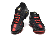Front view of black Nike Air Max Plus III sneakers with red detailing.
