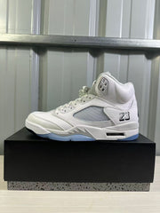 Side profile of a white and silver high-top sneaker with mesh panel and 23 heel detail.