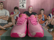 Front view of the pink Nike basketball shoes showing the laces, padded tongues, and textured toe areas.