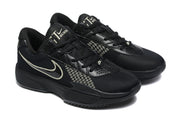 Pair of black lace-up sneakers shown from a front three-quarter angle with perforated toe panels.