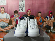 Front view of white high-top sneakers with blue accents and black tongue details
