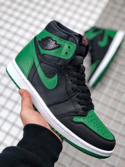 Close-up angled view showing the green perforated toe, black overlays, laces, and ankle emblem.