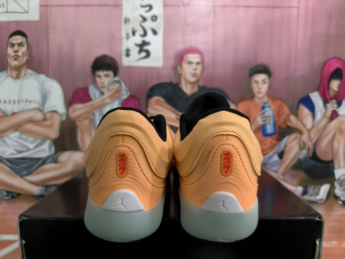Rear view of orange-toned Jordan sneakers with black collars, light gray heel details, and translucent-looking outsoles.