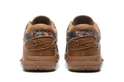 Rear view of the brown sneakers showing padded collars, decorative laces, and outsole details.