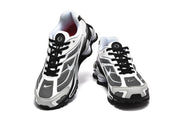 Top and front view of the Nike Shox Ride 2 sneakers with black laces and a white, black, and gray upper.