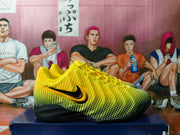 Side view of a yellow and black Nike basketball shoe with a black-and-gold Swoosh