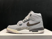 Full side view of the sneaker highlighting the grey, white and brown color blocking and elephant-print panel.