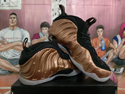 Pair of bronze and black high-top sneakers shown from a three-quarter angle on a black shoebox.