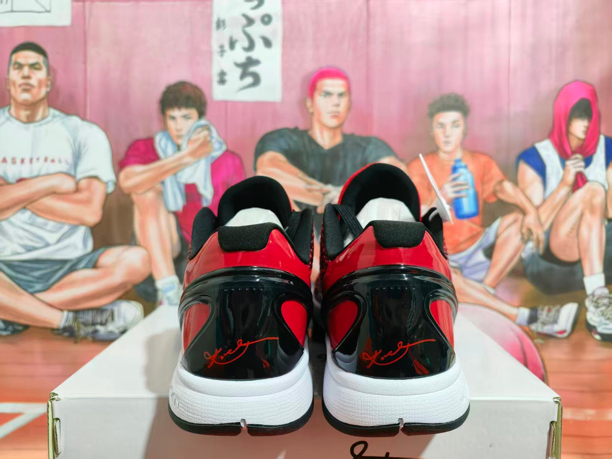 Rear view of red and black Nike basketball sneakers showing glossy black heel panels, red accents, white midsoles, and a box.