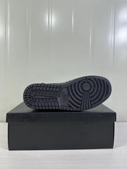 Black rubber outsole with circular traction pattern displayed on a black shoebox.