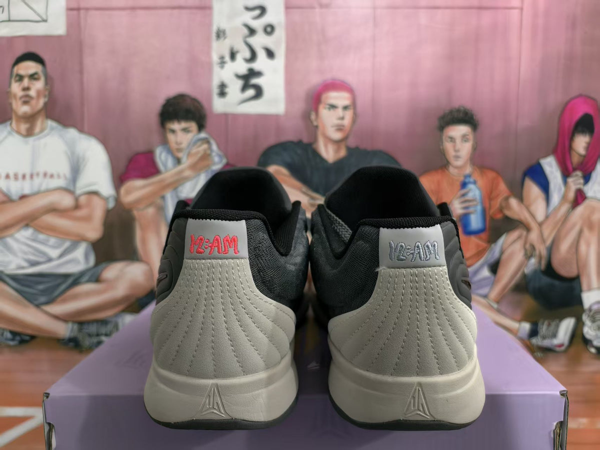 Rear view of gray and black Nike basketball sneakers showing padded collars, stitched heel panels, and off-white midsoles.