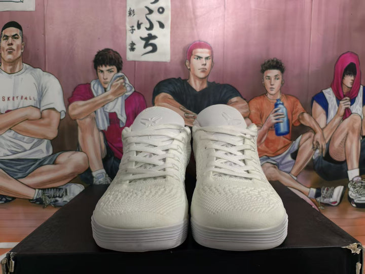 Front view of white Nike basketball sneakers with tonal laces and textured uppers.