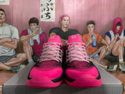 Front view of the pink and black Nike basketball shoes with pink laces and patterned toe panels.