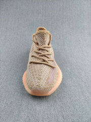 Top-front view showing the textured tan upper, tonal laces, and mauve side stripe.