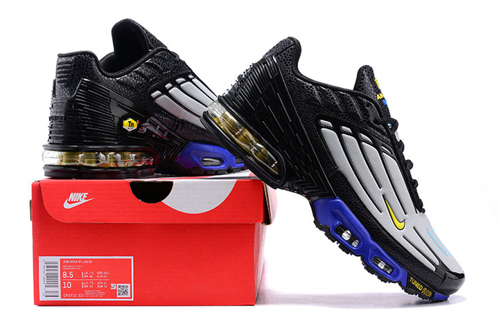 Nike Air Max Plus 3 sneakers in black, grey, and blue displayed with a Nike shoebox.