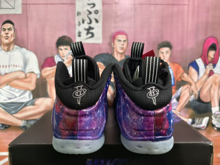 Rear view of purple and blue starry basketball sneakers with black collars and translucent white outsoles.