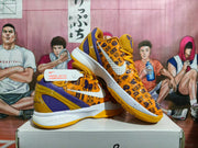 Angled view of paired yellow and purple Nike basketball shoes displayed on a shoe box.