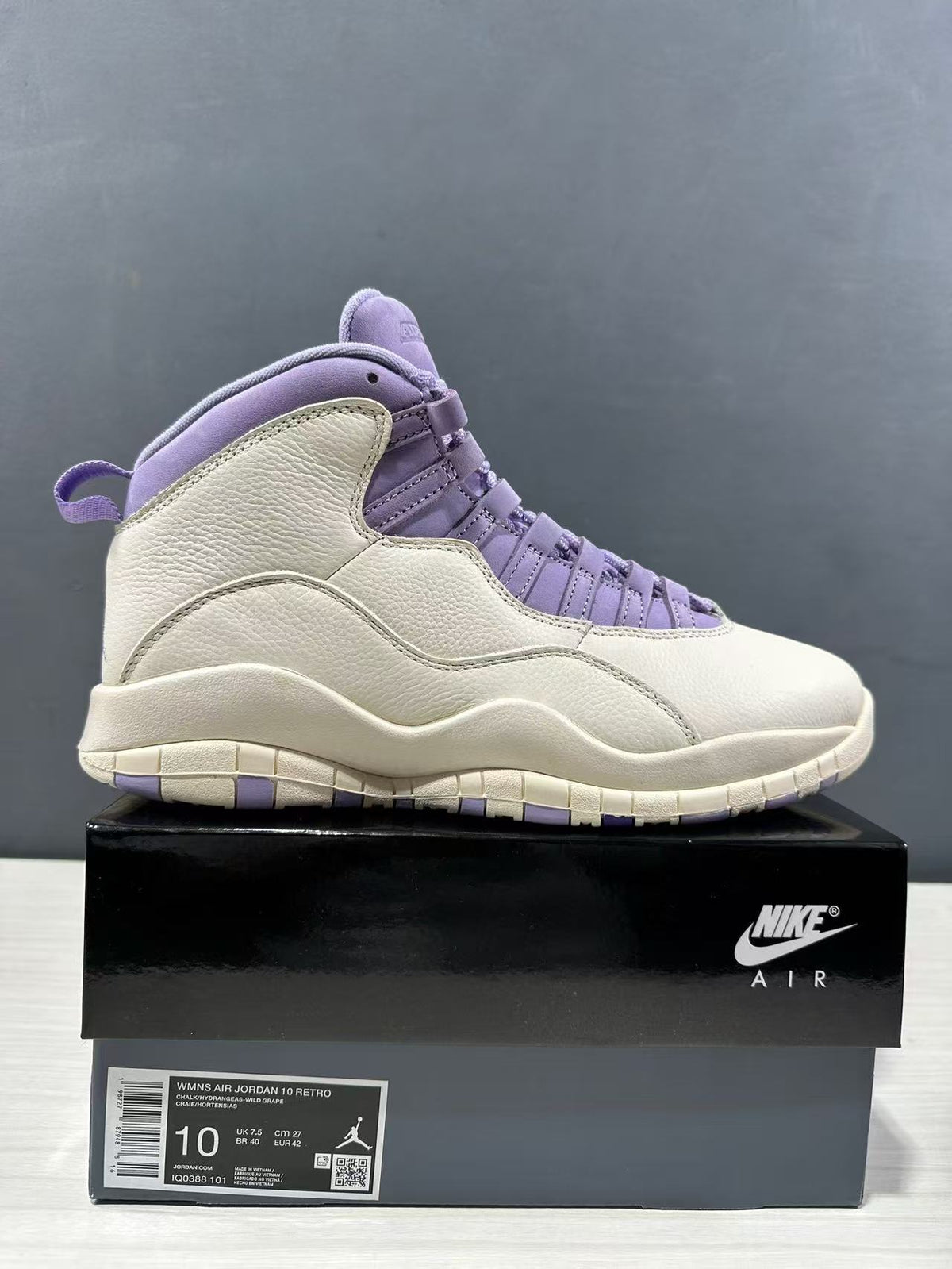 Side view of a white and purple high-top Jordan Air Jordan 10 sneaker displayed on its box; the box label shows size EU 42 and style code IQ0388-101.
