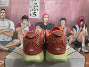 Rear view of the pair showing the orange-accented heel detailing, padded collars, and pale green heel sections.