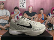 Side profile showing the raised textured upper, black Swoosh and sculpted white midsole.