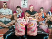 Rear view showing pink textured heels with orange “Thank You” embroidery.