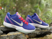 Three-quarter view of the pair showing the textured upper, red laces, white Swoosh, and pale translucent outsole.