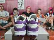 Rear view of purple and white Nike basketball sneakers placed on a shoebox.