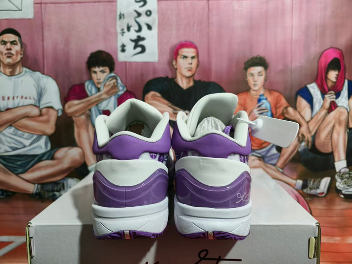 Rear view of purple and white Nike basketball sneakers placed on a shoebox.