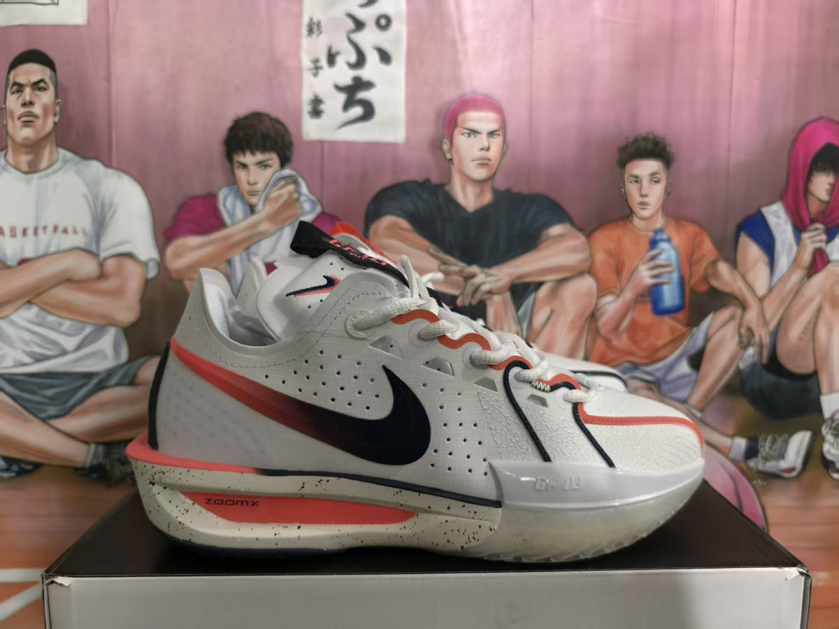 Side view of white Nike basketball sneakers with mismatched black and red accents, perforated uppers, and speckled midsoles.