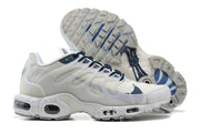 Side view of white and navy sneakers with a speckled outsole