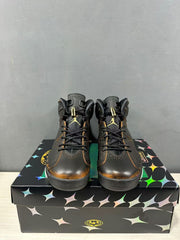 Front view of black high-top Jordan Air Jordan 6 sneakers showing the laces, padded tongues, and gold-toned accents.