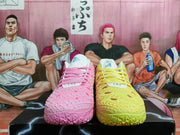 Pink and yellow Nike basketball shoes shown from the front.