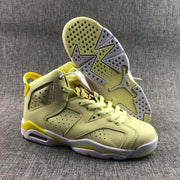 Angled product view with one sneaker resting on its side to show the perforated outsole, heel cushioning window, and upper construction.