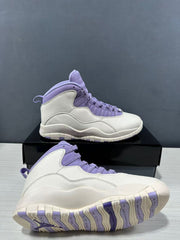 Two white and purple high-top sneakers shown from angled side and outsole views.