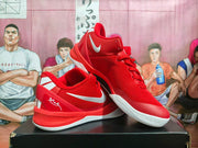 Angled view of red and white Nike basketball sneakers showing the side Swoosh and heel graphics.