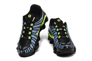 Front views of Nike Shox TL sneakers showing the lace-up design and bright accent details.
