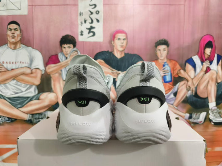 Rear view of gray basketball shoes with black heel detailing and white outsoles.