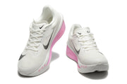 Pair of white Nike Zoom Fly 6 shoes with black Swoosh graphics and pink sole accents.