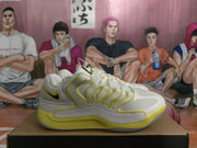 Side profile of a white and yellow Nike basketball shoe