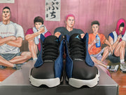 Front view of black and deep blue high-top Jordan basketball sneakers with tongue branding